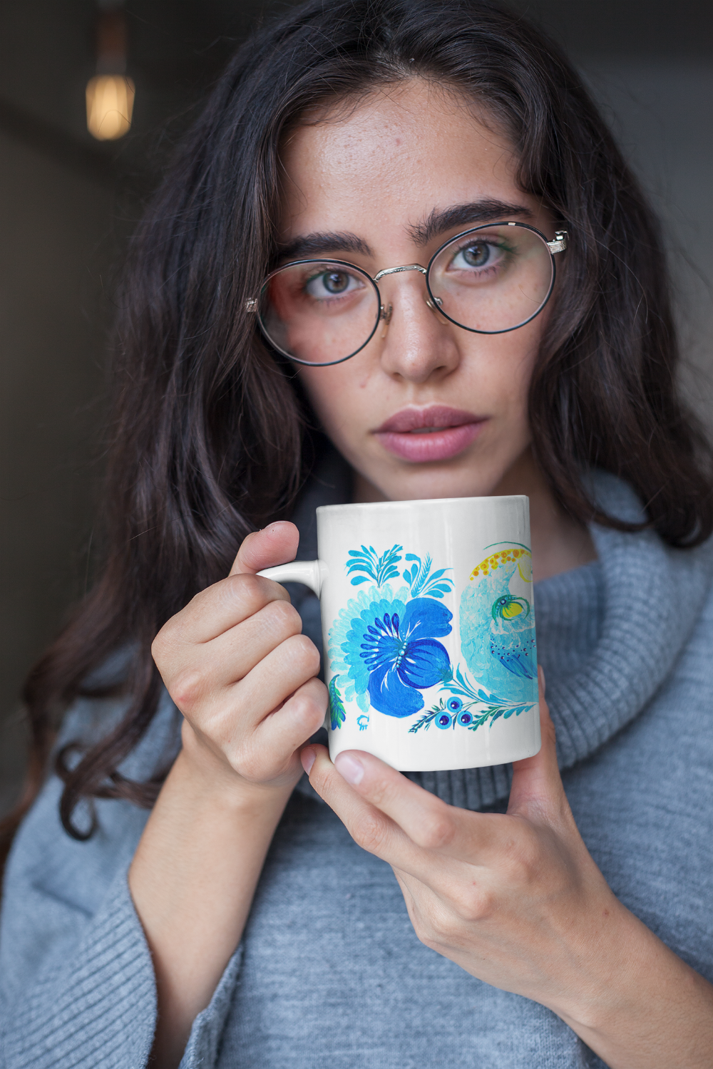 Ceramic mug with bird art – white mug featuring Petrykivka painting in blue and yellow tones