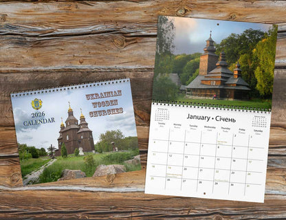 Two Ukrainian wooden churches calendars on a wooden surface. 2026 calendar, wall calendar, religious gift, gifts from Ukraine