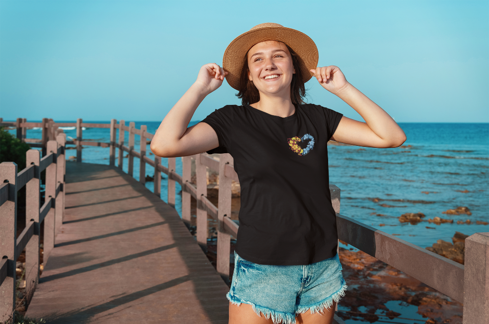 support to ukraine, black t shirt with traditional Ukrainian floral heart design in blue and yellow colors